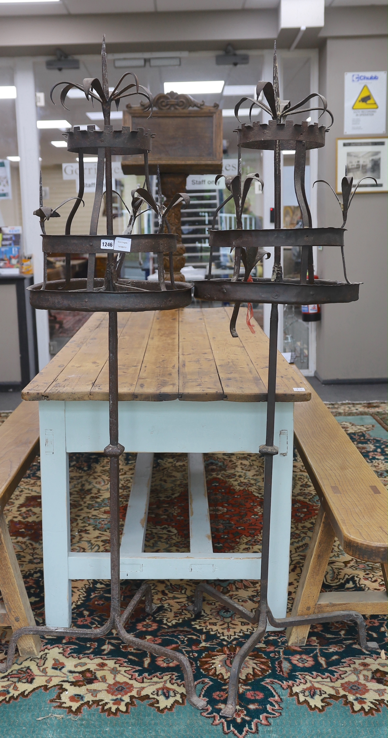 A pair of wrought iron floor standing candlestands, in 17th century style, height 171cm, Provenance- Brede Place, East Sussex, a former residence of the Frewen family from 1712-1936.